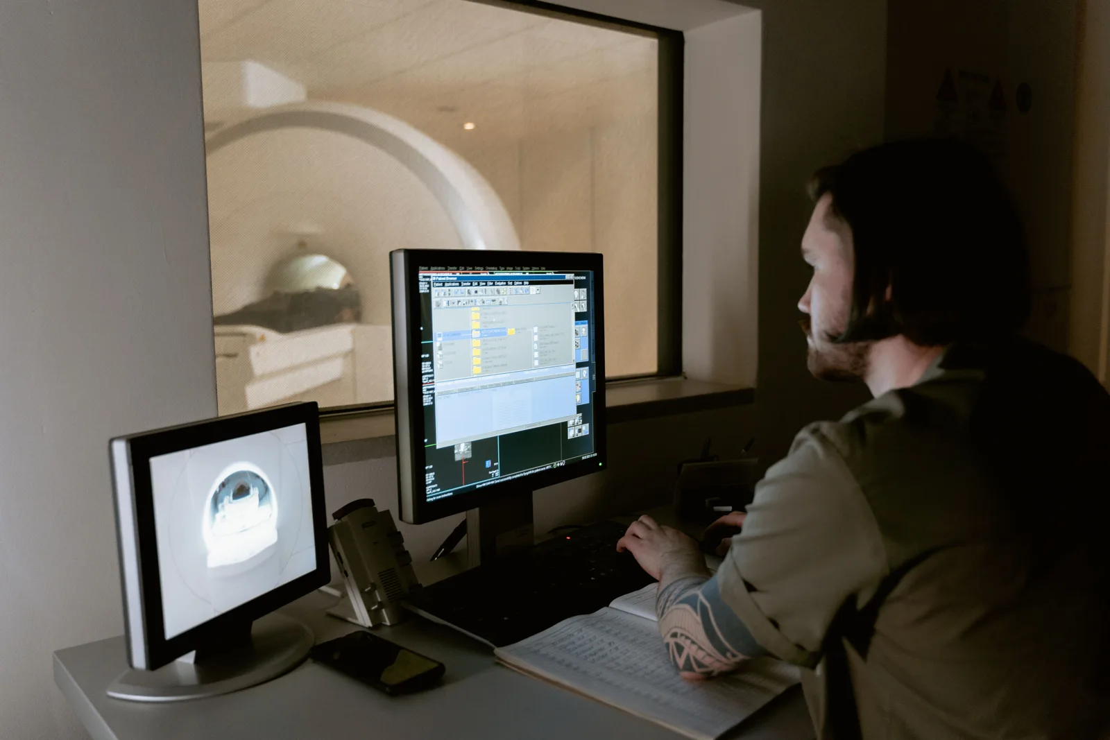 Radiology professional reviewing imaging on diagnostic monitors