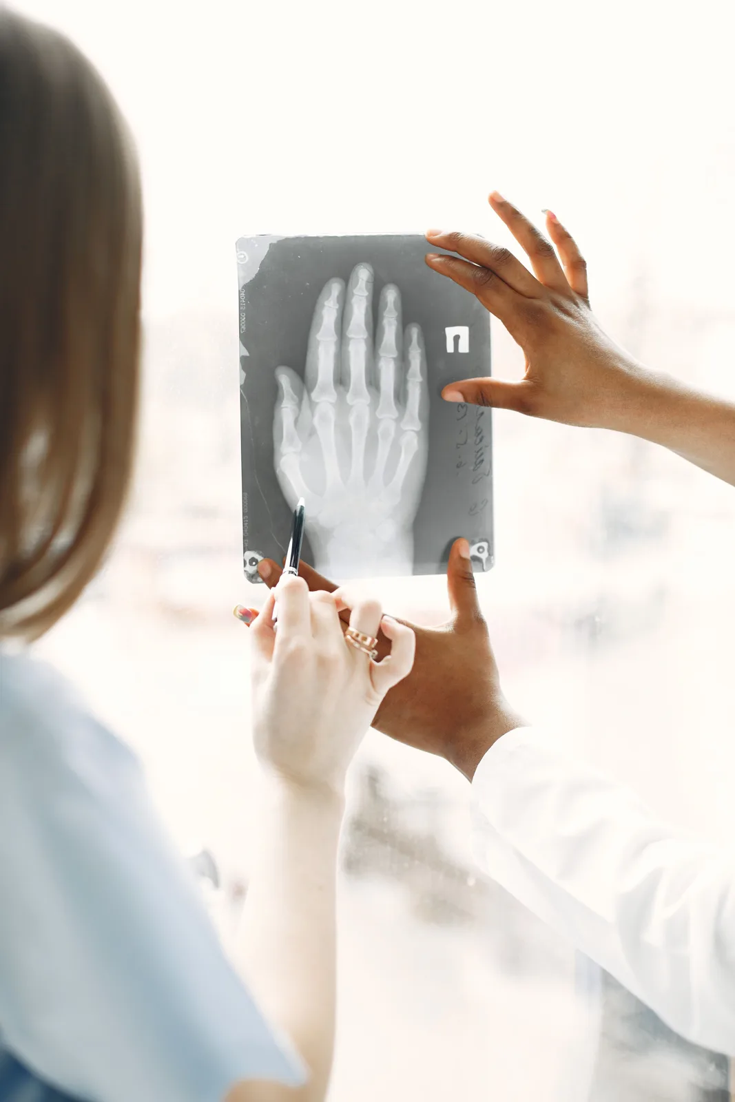 Clinicians discussing a hand X-ray