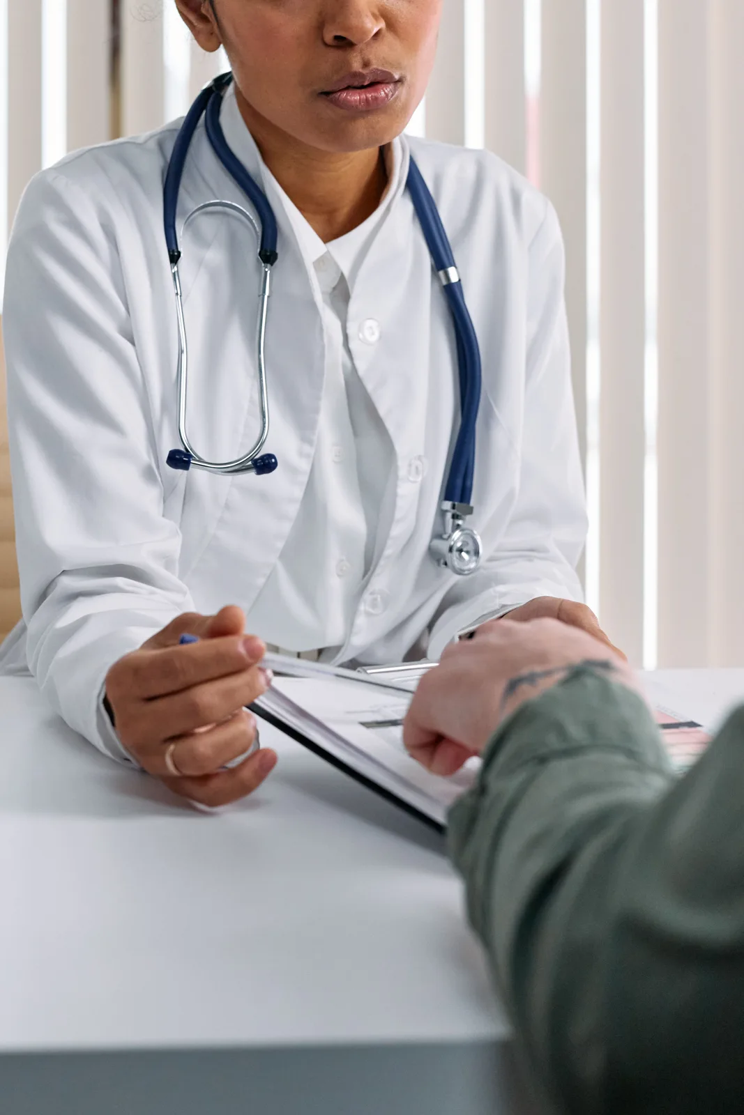 Doctor and patient discussing paperwork during a consultation