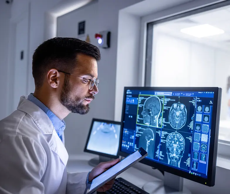 Illustrative clinician viewing brain MRI images on a diagnostic workstation